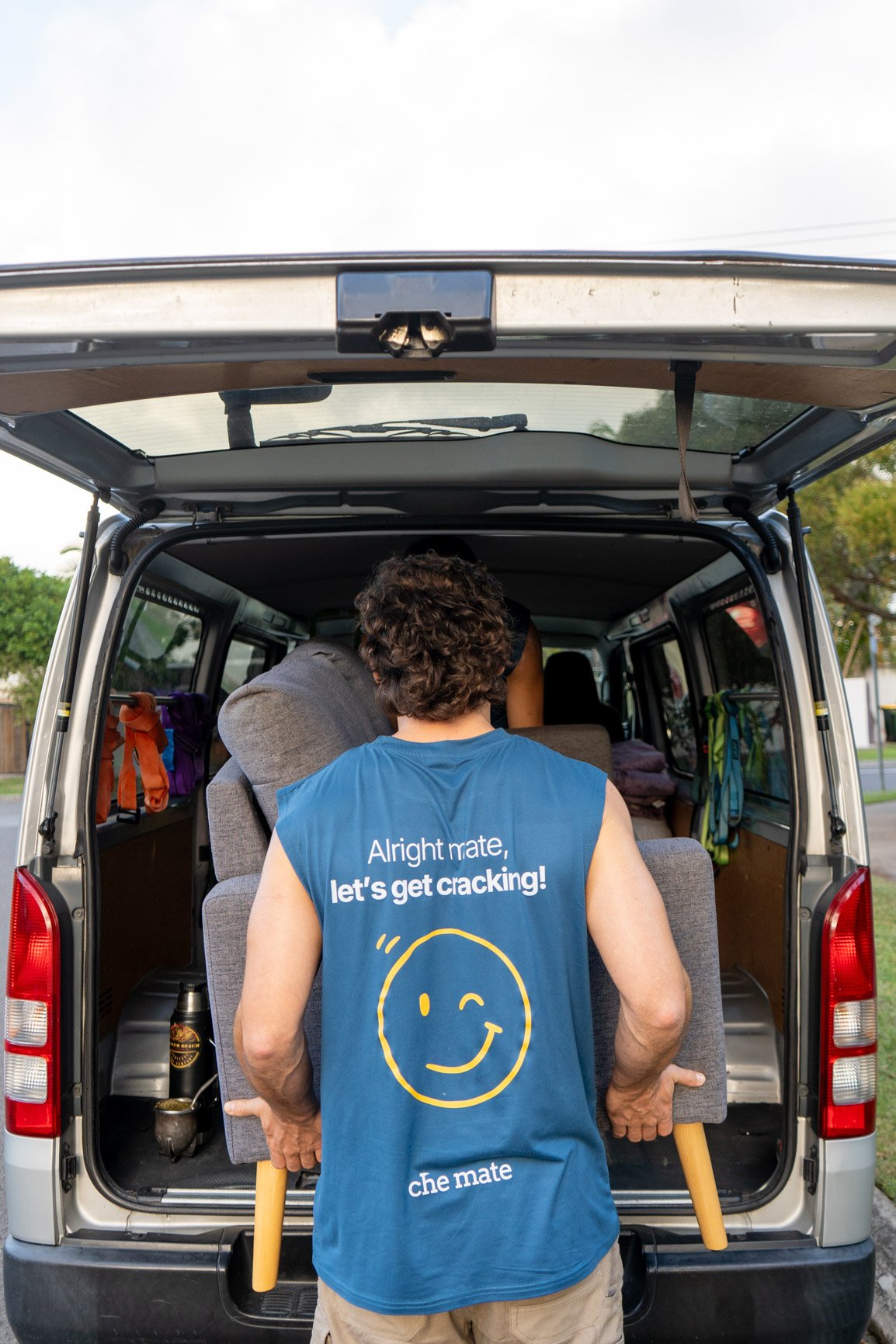 A clipboard and phone on folded moving blankets in the van